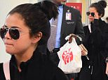 EXCLUSIVE: Selena Gomez was spotted arriving at Laguardia Airport in NYC on Monday evening, after being stuck in NYC after snowstorm Jonas. She was scheduled to leave after her SNL Performance, but had multiple flights cancelled because of the weather. She wore a long coat, Python Boots and carried her laptop , as she headed into the airport. She posed for photos with fans before boarding her plane to visit her family in Dallas\n\nPictured: Selena Gomez\nRef: SPL1214733  250116   EXCLUSIVE\nPicture by: 247PAPS.TV / Splash News\n\nSplash News and Pictures\nLos Angeles: 310-821-2666\nNew York: 212-619-2666\nLondon: 870-934-2666\nphotodesk@splashnews.com\n