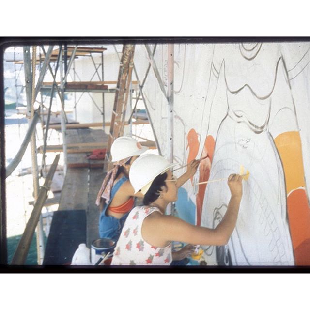 (From archive website) Mujeres muralistas work on a mural in #ChicanoPark, #SanDiego. Pro-line vinyl paints on acid-etched concrete of Chicano Park freeway support column. October 1975.