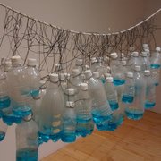 Bronx Museum of the Arts - Clear plastic bottles semi-filled with blue liquid hanging on a rope - Bronx, NY, United States